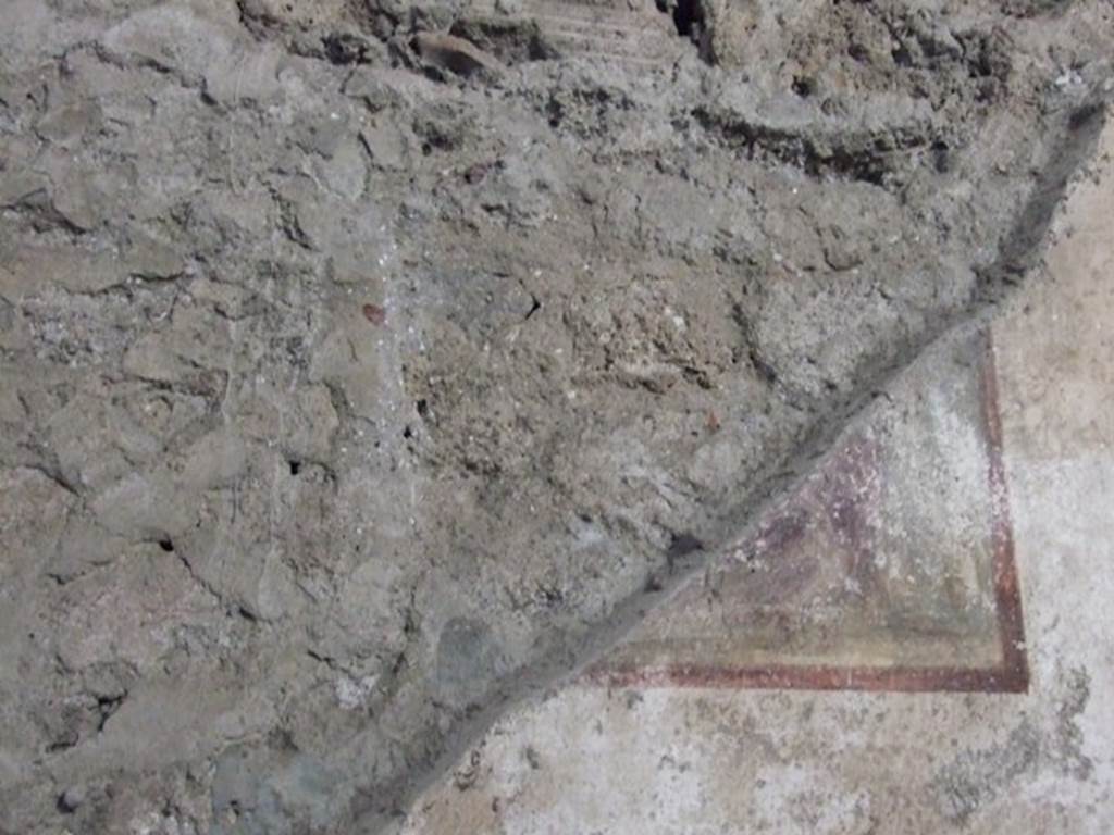V.2.i Pompeii. December 2007. Room 9, remaining corner of a wall painting on west wall. According to Mau, on the west wall only the lower corner was conserved.  He recognised that near to the right margin was the foot of a large chair. To the left of this chair, possibly a sceptre and below, an eagle.
He thought, without doubt, this would have been Giove. See Mau, A., 1893. Mitteilungen des Kaiserlich Deutschen Archaeologischen Instituts, Roemische Abtheilung Volume VIII. (p.46)
Sogliano thought, in NdS, that the remaining fragment of this painting on the west wall would have represented the child Hercules strangling the serpents in the presence of Zeus. 
See Notizie degli Scavi, 1896, (p.427)