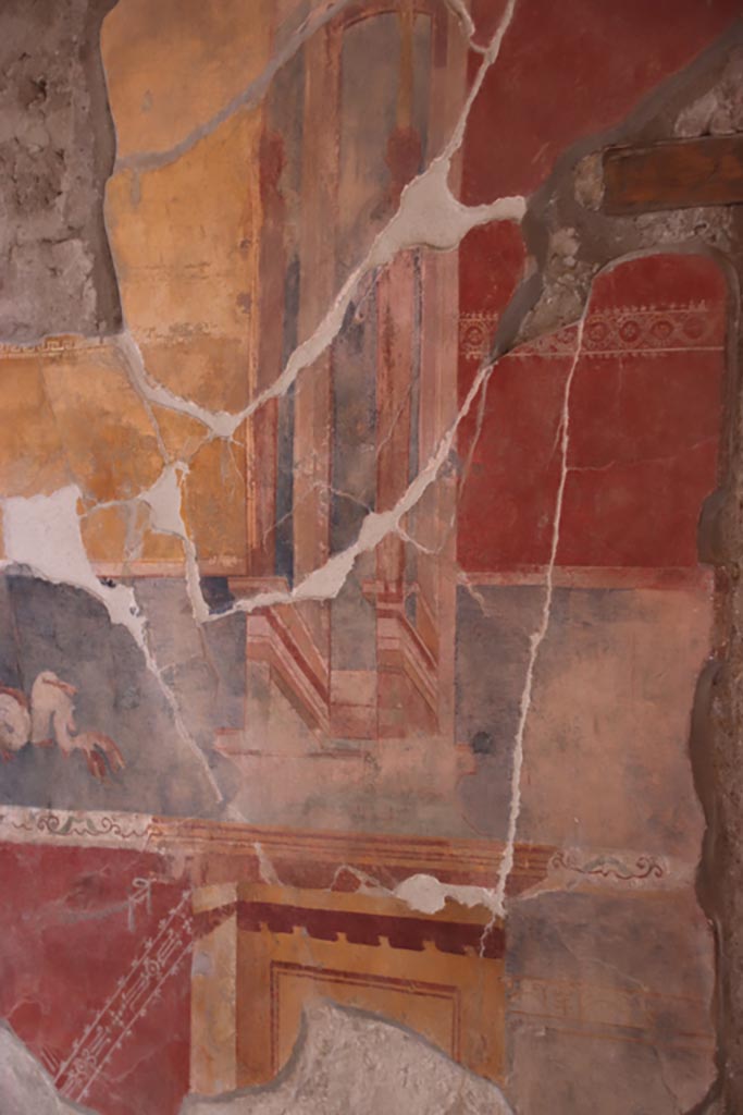 V.2.i Pompeii.  October 2023. 
Tablinum 7, detail from east wall on south side of central yellow panel. Photo courtesy of Klaus Heese.
