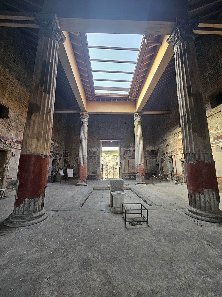 V.2.i Pompeii. November 2024.
Room 1, looking north across atrium with compluvium, from room 7, tablinum. Photo courtesy of Annette Haug.