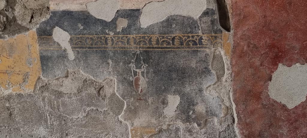V.2.i Pompeii. December 2023. Tablinum 7, detail from north end of zoccolo on lower west wall. Photo courtesy of Miriam Colomer.