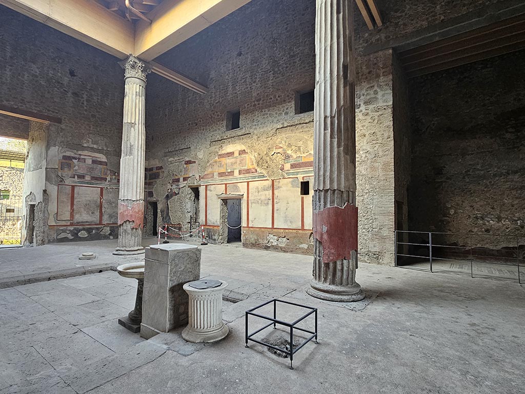 V.2.i Pompeii. November 2024.
Looking across impluvium towards north-east corner of atrium from south side, with east ala, on right. Photo courtesy of Annette Haug.