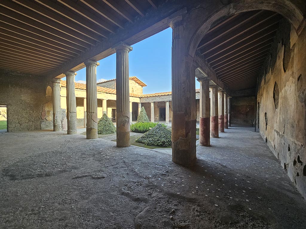 V.2.i Pompeii. November 2024. 
Looking east across north portico, on left, and looking south along west portico, on right.Photo courtesy of Annette Haug.