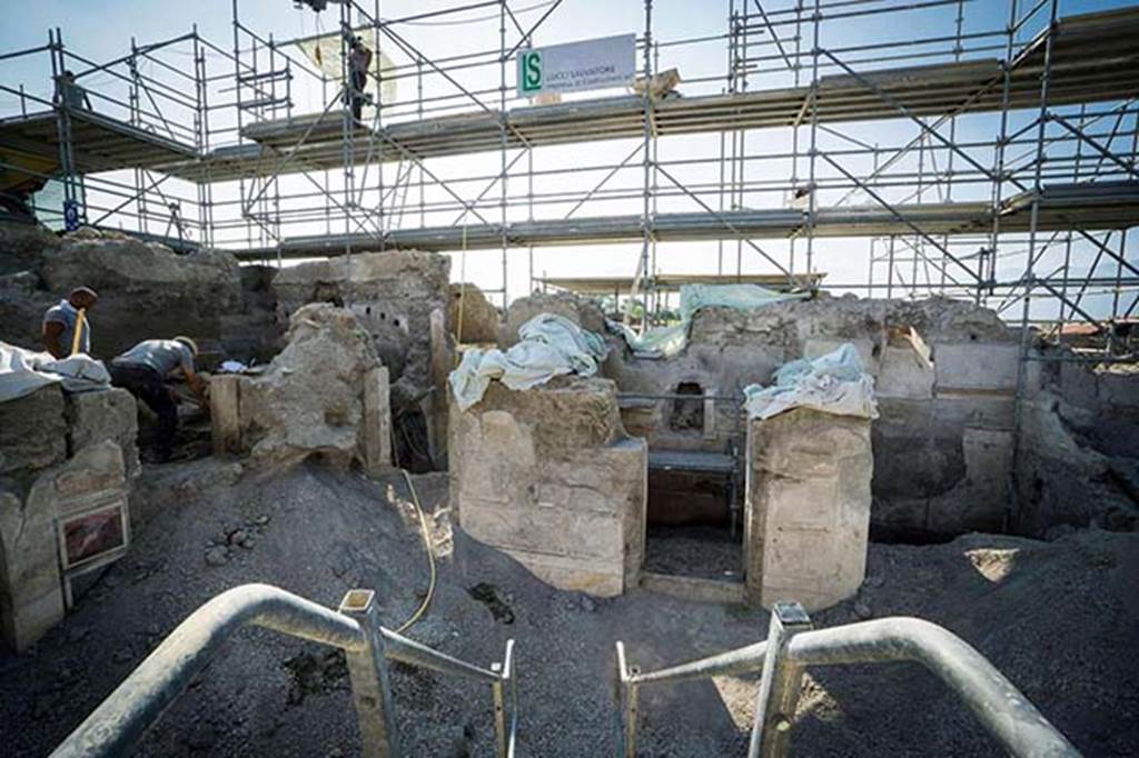 V.2.15 Pompeii. August 2018. The two excavators are working in room A3, which is on the east side (left).
On the south side of atrium A12 are rooms A17, A11 in the centre and room A13 on the right.
Photograph © Parco Archeologico di Pompei.