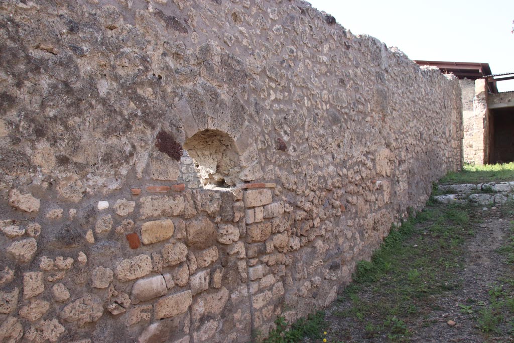 V.3.4 Pompeii. October 2023. 
Looking north along west wall of entrance corridor, with blocked doorway to V.3.3. Photo courtesy of Klaus Heese.