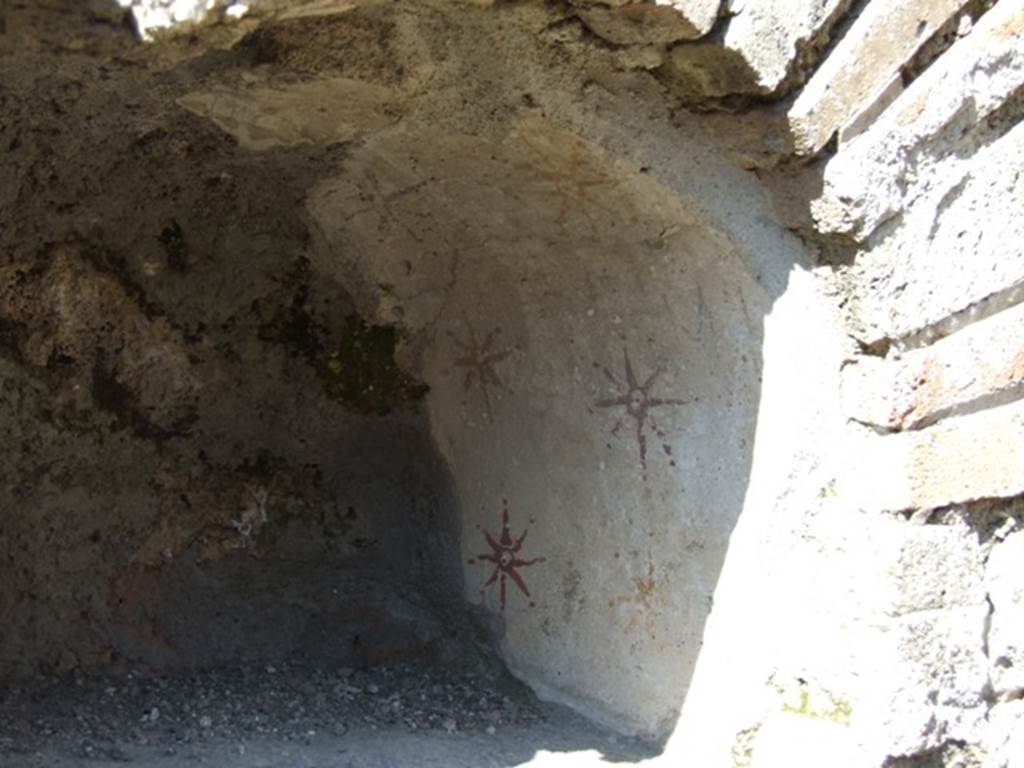 V.3.9 Pompeii. March 2009. Niche with remains of yellow and red painted stars. See Boyce G. K., 1937. Corpus of the Lararia of Pompeii. Rome: MAAR 14.  (114, plate 22,3)