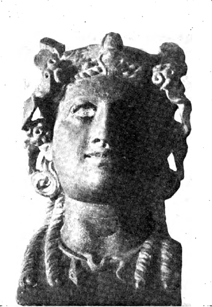 V.3.10 Pompeii. 14th September 1901. Bust of bacchante found in north-east corner of small garden.
According to Sogliano, a monopodium was found, made of two pillars, the one behind the other, and surmounted by a small little shelf of Bardiglio marble, on which was set a pretty head of a Bacchante.
It was of antique yellow marble, crowned with ivy with berries, adorned with necklace, in which wraps a snake.
Long curls fall over the shoulders, with eyes of glass paste (now non-existent) outlined in black.
Smiling with a slightly open mouth, which shows the top row of the teeth.
It is a good Roman work. 
Of the two pillars, the front is of African marble; the back, broken into three pieces, is of coral rubble.
See Notizie degli Scavi di Antichità, 1901, p. 403, fig.3.