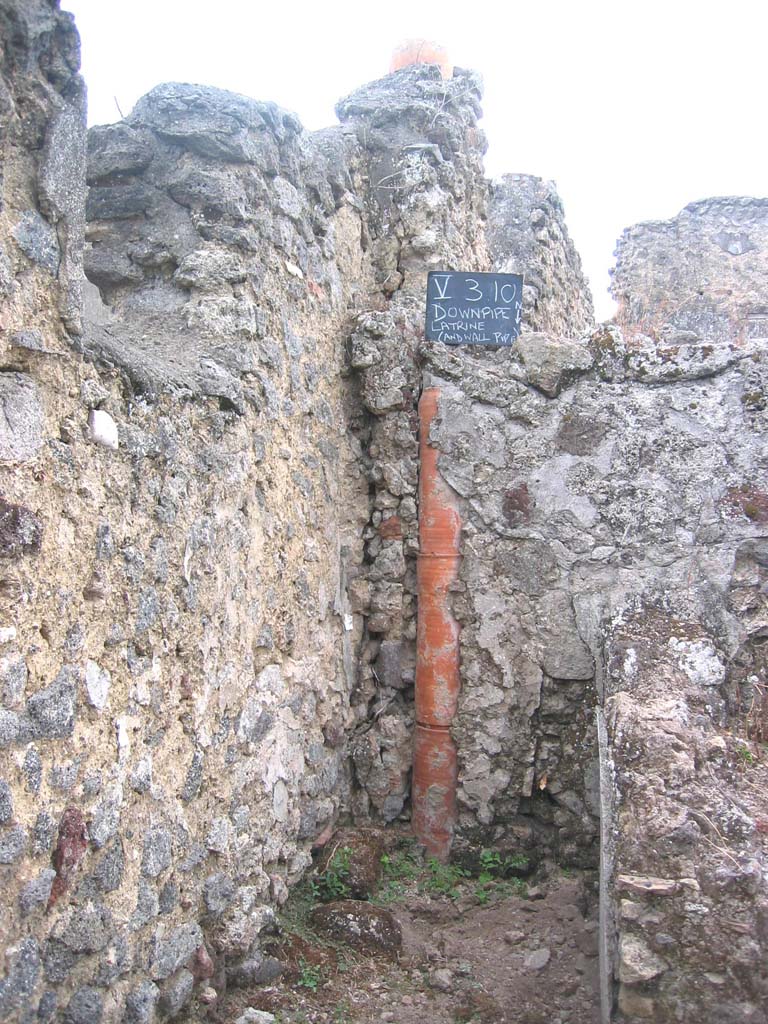 V.3.10 Pompeii. July 2008. 
Looking south towards latrine and downpipe from an upper floor latrine. Photo courtesy of Barry Hobson.