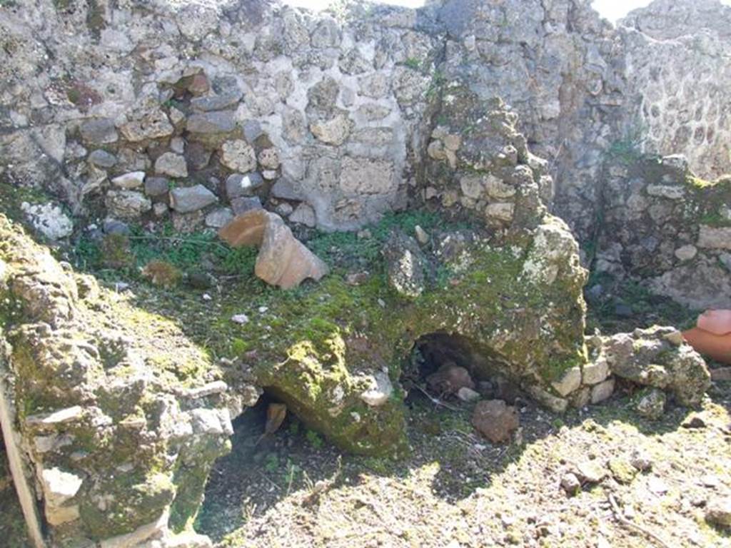 V.3.10 Pompeii. March 2009. Hearth on south wall of kitchen.  According to Boyce, a single serpent was painted on the wall beside the hearth. No longer visible. He quoted Not.Scavi, 1902,203 as his reference. See Boyce G. K., 1937. Corpus of the Lararia of Pompeii. Rome: MAAR 14. (p.39, no.115)