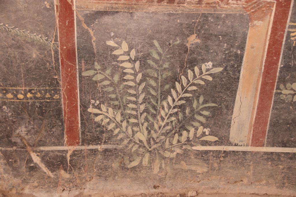 V.3 Pompeii. Casa del Giardino. October 2022.   
Room 1, south wall, detail of painted decoration on zoccolo at west end. Photo courtesy of Klaus Heese.