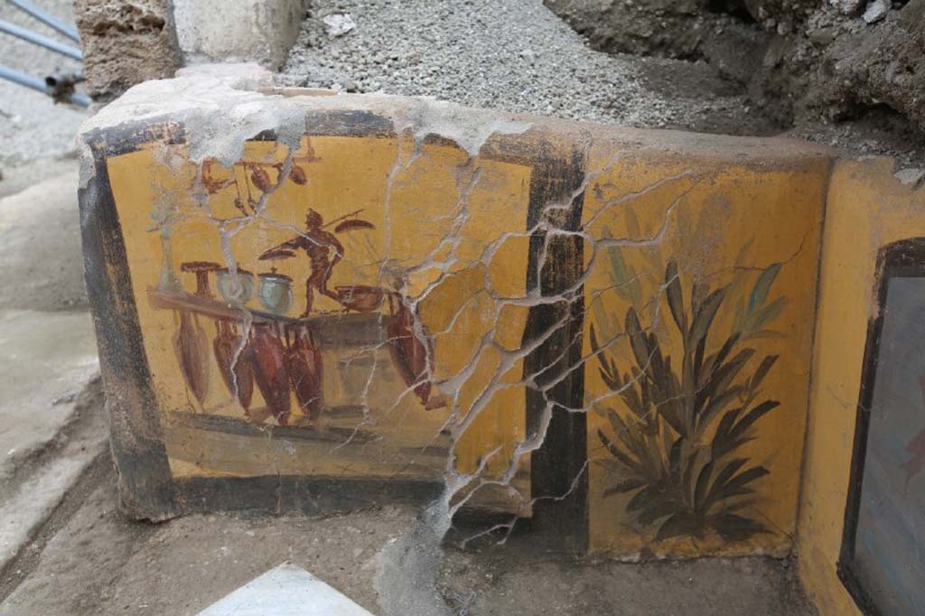 V.3 Pompeii. March 2019. Thermopolium at the crossroads between Vicolo delle Nozze d’Argento and Vicolo dei Balconi. 
This side of the counter is most probably the illustration of the business conducted in the shop, almost as if it were a shop sign. 
The discovery of amphorae during excavation, which were located in front of the counter, reflected the painted image exactly.
V.3 Pompei. Marzo 2019. Termopolio all'incrocio tra il Vicolo delle Nozze d'Argento e il Vicolo dei Balconi.
Le decorazioni del bancone raffigurano su un lato, l'illustrazione, molto probabilmente, dell'attività stessa che si svolgeva nella bottega, quasi come un'insegna commerciale. 
II ritrovamento di anfore paste davanti al bancone, al momento dello scavo, rifletteva difatti esattamente l'immagine dipinta.
Photograph © of Parco Archeologico di Pompei.