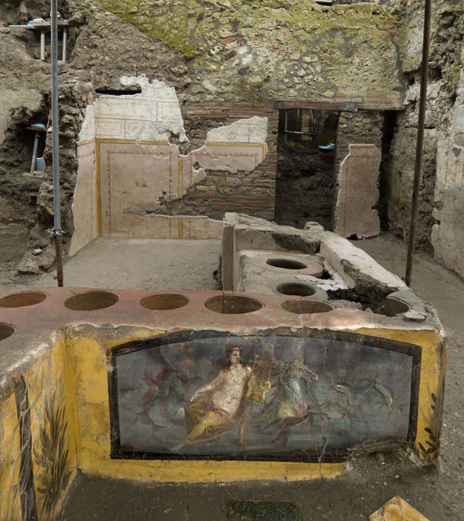 V.3 Pompeii, Thermopolium with painting of nereid. December 2020. Looking towards the south/rear of the thermopolium with wall decoration and door.
V.3 Pompei, Termopolio con dipinto di nereide e anfore. Dicembre 2020. Guardando verso la parte sud/posteriore del termopolio con decorazione murale e porta.
Photo by Luigi Spina courtesy of Parco Archeologico di Pompei.