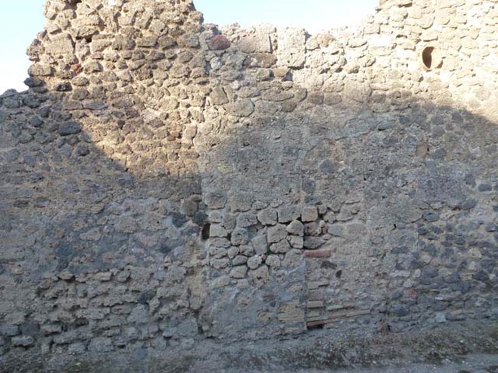 V.4.1 Pompeii. June 2012.  Looking east in Vicolo di M L Frontone towards side wall. Photo courtesy of Michael Binns.