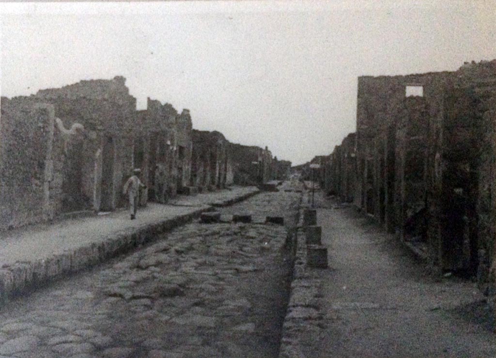 Via di Nola, 1955. Looking west from outside V.4.6, on right.
Image taken in 1955 by an officer serving aboard the HMS Ark Royal. Photo courtesy of Rick Bauer.
Note the column “stumps” along the edge of V.4, outside of the entrances of V.4.3/4/5. 
According to CTP, “Of the three columns on the sidewalk in front of numbers 3, 4 and 5, drawn by Mau, no traces remain in situ.
It should be noted that Spinazzola drew up a reconstruction of these, showing four columns (Spinazzola, 1, 1953, p.115, fig.140).”
See Van der Poel, H. B., 1986. Corpus Topographicum Pompeianum, Part IIIA. Austin: University of Texas. (p.78).