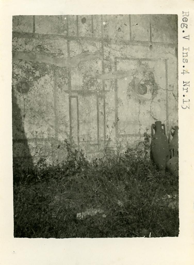 V.4.13 Pompeii. Pre-1937-39. Triclinium “S”, north wall.
Photo courtesy of American Academy in Rome, Photographic Archive.  Warsher collection no. 683
According to Sogliano, Triclinium “S” was decorated with walls with a white background. 
The room had doorposts of wood and probably the threshold was also of the same material. 
The white background of the walls was partitioned into large square ornamentations: 
in the middle of each of two of the squares on the north wall were medallions with blue (paonazzo) backgrounds: 
the medallion on the left was better preserved and showed a flying griffin. 
He also said that this room was also used as a bedroom, as shown by the bed recess in the west wall.
See Notizie degli Scavi di Antichità, 1905, (p.96).
