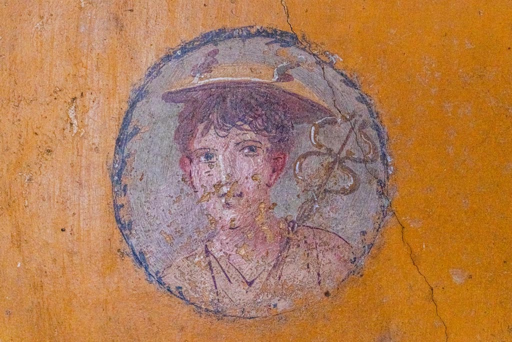 V.4.a Pompeii. October 2023. 
Room ‘i’, wall painting of boy from west wall of cubiculum, on north side of doorway. Photo courtesy of Johannes Eber.