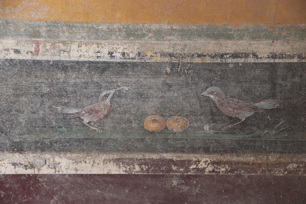 V.4.a Pompeii. October 2023.  
Room ‘g’, detail of bird painting in predella on lower east wall, on south side of central panel. Photo courtesy of Klaus Heese.