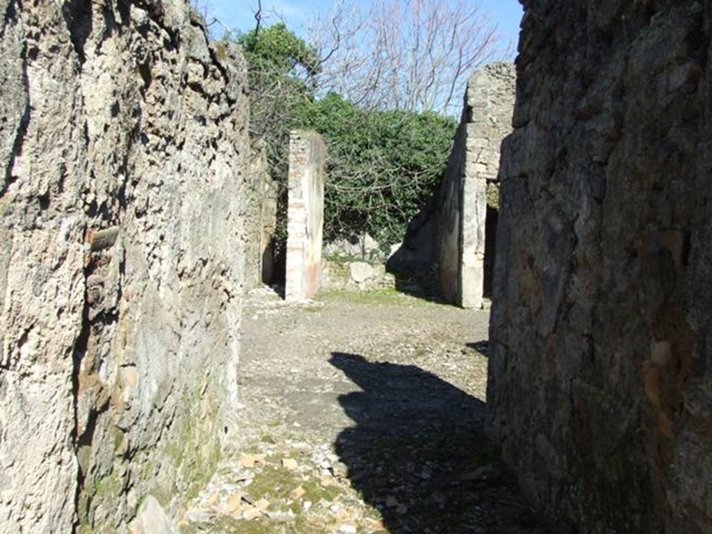 V.4.c Pompeii. March 2009. Looking east across room A, the fauces, towards atrium and tablinum.
According to NdS, (1902) –
In the house in Reg. V that had its doorway opposite to the one at V.3.11 (therefore V.4.c), I verify that on the 1st May, an important discovery was made of 4 skeletons with the following objects –
Large gold bracelet in the shape of facing serpents;
Two gold rings set with stone;
A pair of earrings;
One aureus of Nero, and two of Domitian;
29 silver coins, silver bronze mirror
The death of the unfortunates would have seemed to have been from the fire that caused the floor of the upper room, where they had taken refuge, to collapse, and whose violence had partly burnt their bones and left traces on the paintings on the walls.
The house, to judge from the part excavated up until now, will not have been very large, nor as beautiful as the one opposite to it (V.3.11). 
However, it had in the tablinum fairly good paintings showing the four seasons (Autumn completely disappeared, and in the atrium was a painting of Mercury with purse and staff/caduceus, very similar to the one existing in the thermopolium V.4.6-7 (see Notizie1899, p. 343) however, “ours” had a large serpent curled/tangled at his feet.
R.PARIBENI.
See Notizie degli Scavi, 1902, (p.276).