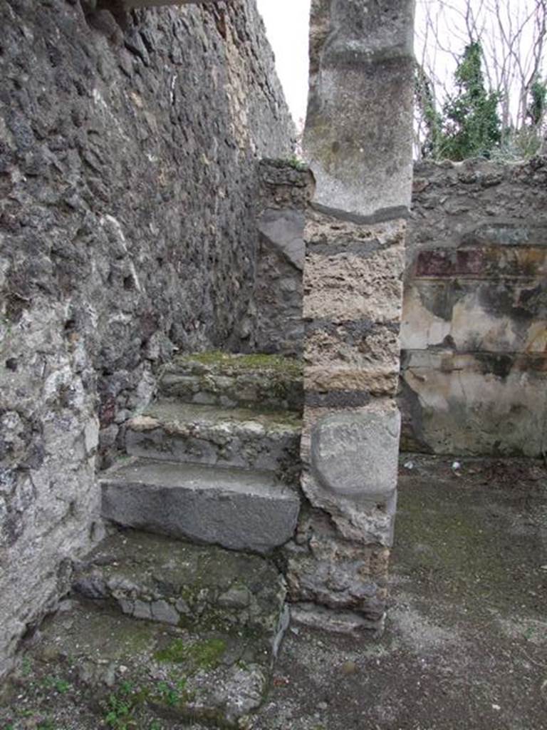 V.5.2 Pompeii. December 2007. Looking south to steps to upper floor in south-east corner of atrium. The doorway on the west side (right) of the steps led to a cubiculum “d”. The south wall, visible in the background, was decorated in the first style. These six masonry steps would have continued with wooden stairs. These steps and stairs would have been against the east wall and led above both cubiculum “d” and cubiculum “c”. See Notizie degli Scavi di Antichità, 1895, p.150