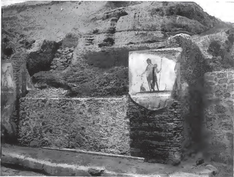 V.6.1 Pompeii. 1906. Paintings of Mercury left and Bacchus right. 
See Notizie degli Scavi di Antichità, 1906, p. 55 fig. 5.
Kuivalainen describes –
“A composition of two standing figures on a white background. The higher, in the middle, is a youth leaning on a shoulder of a satyr; he wears a cloak which hangs down from his left arm and covers his thighs; his right arm is stretched down, and he holds a cantharus from which he pours wine into the mouth of a seated panther on his right side, with an artistically folded tail. The smaller satyr has a pine wreath on his head, and holds a thyrsus in his left hand. On the right is a small tree trunk.”
Kuivalainen comments –
“This simple and domestic scene takes place in a natural setting.”
See Kuivalainen, I., 2021. The Portrayal of Pompeian Bacchus. Commentationes Humanarum Litterarum 140. Helsinki: Finnish Society of Sciences and Letters, (p.159, F1).