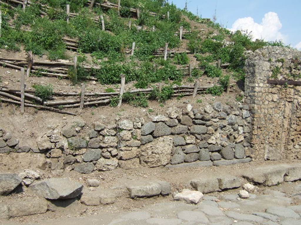 V.6.2 Pompeii. May 2006. Looking east to unexcavated doorway, on right.