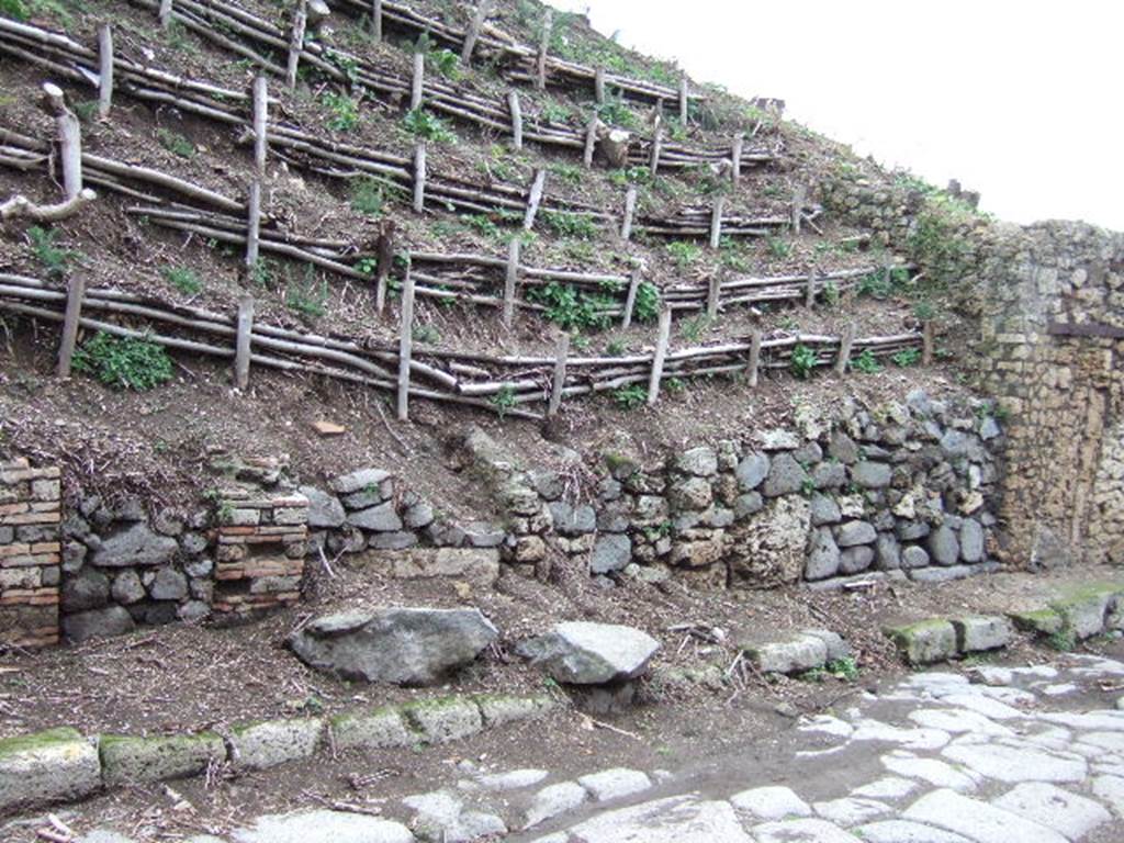 V.6.3 Pompeii, on left. December 2005. Looking east to unexcavated doorways. V.6.2, can be seen, on right.