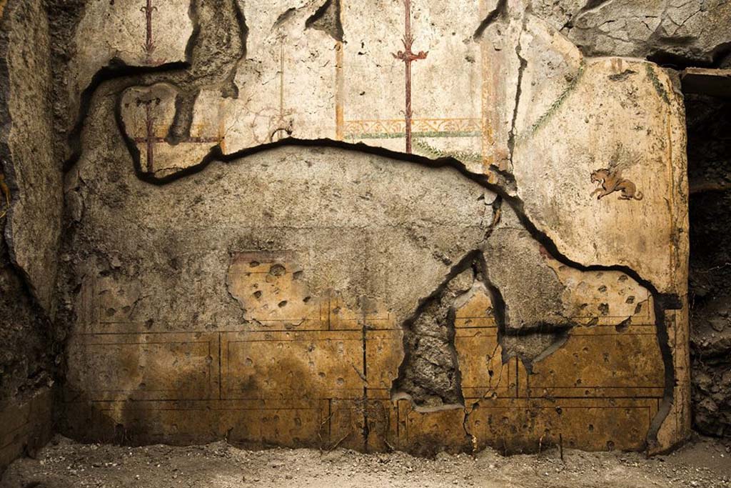 V.7.7 Pompeii. 2018. Room to the west of the entrance, north wall with older fresco decoration covered with a richer fourth-style decoration. 
It is possible that the oldest decoration is prior to the earthquake of 62, while the last decoration refers to renovations following this event.
Photograph © Parco Archeologico di Pompei.