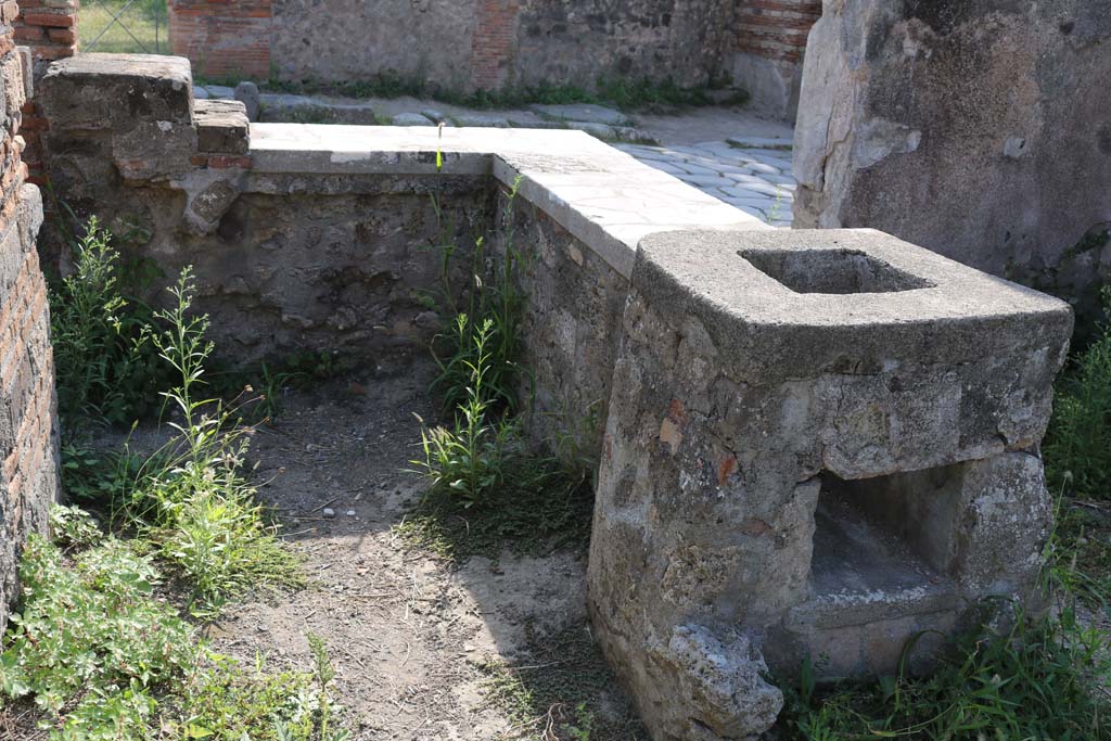 VI.1.2, Pompeii. December 2018. 
Looking west across hearth and counter from rear, towards Via Consolare. Photo courtesy of Aude Durand.