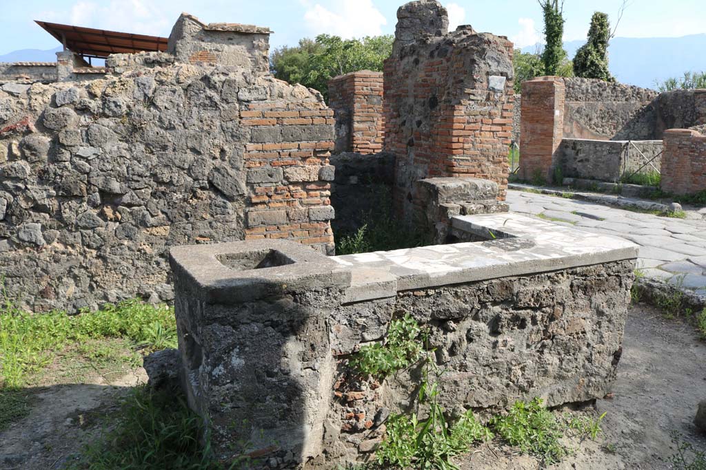 VI.1.2 Pompeii. December 2018. Looking south across counter and hearth, from north side. Photo courtesy of Aude Durand.