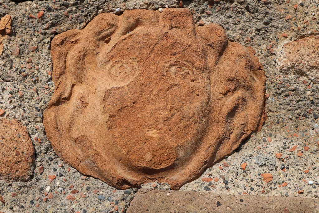 VI.1.4 Pompeii. December 2018. 
Terracotta mask of head embedded in masonry on south side of entrance doorway. Photo courtesy of Aude Durand.