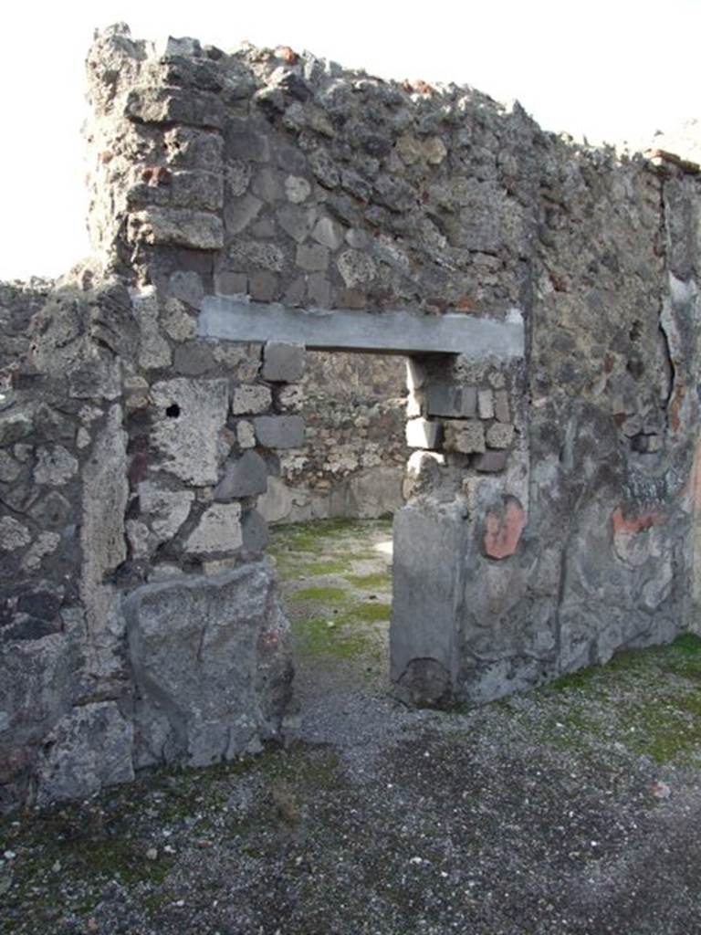 VI.1.7 Pompeii. December 2007. Doorway to room 10, from atrium, looking north-west.
This room was reported as being excavated on the 22nd July 1784 (see PAH 1, 2, (p.21-22), and 29th July 1794, and Addenda (p.166-167).
ADDENDA, (p.166-167)
22 July 1784 Si scoprono due stanze appartenenti alla terza abitazione vicino alla Porta di pompei, nel lato settentrionale. Questa era qualla che va sotto il nome delle Vestali. 
Curioso musaico di vetri e pastiglie in una della suddette stanze, con uno specchio in mezzo. Questa camera pare che fosse addetta all’uso di mangiare, ossia un triclinio.
29 July 1784
Musaico con due delfini, ed in mezzo di essi un’ancora, che orna la soglia della porta piu grande d’ingresso al suddetto triclinio.
(translation – 
22ND July 1784 Two rooms belonging to the third dwelling near the Gate of Pompeii on the north side, were excavated. This was the one that goes by the name of the Vestals.  
A curious glass and paste mosaic was found in one of these rooms, with a mirror(?) in the middle.  This room seems to have been used for eating, i.e. a triclinium. 
29th July 1784
Mosaic with two dolphins, and between them an anchor, which adorned the largest door threshold at the entrance to the aforementioned triclinium.