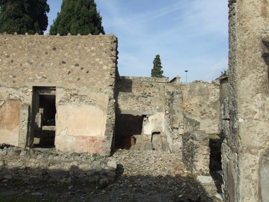 VI.1.7 Pompeii. December 2007. Looking north from outside room 27.
Doorway in room 12 to peristyle, on left.  Room 28 centre with room 24 at rear, and doorway entrance of room 27, on right. Rooms 24-28 would have been the bath suite. According to Robinson and Jones, a bath suite was constructed on the north-east side of the atrium. There was an entrance, hot and warm rooms, a hot plunge pool, a wash room, and, in the middle of the large peristyle, an open-air swimming pool.
See article called Imperial Pompeii, a city of extremes? in Current World Archaeology, Number 4, March/April 2004, p.32-39.