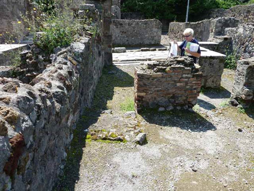 VI.1.17 Pompeii.  May 2010. Looking west across bar towards Via Consolare 
In the rear room, the remains of the steps to upper floor can be seen on the left.