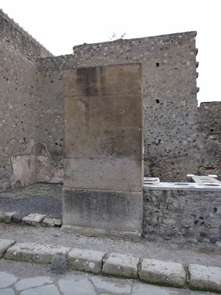 Pilaster between VI.2.2 and VI.2.1. Possible site of eituns?  According to Cooley, Oscan inscriptions (eituns) came to light when the plaster had peeled off the walls after excavation. These were painted on the outer walls of houses near street corners. An example has been found at VI.2.4. These eituns were thought to relate to the military operations from the time of Sulla’s besiege of Pompeii. See Cooley, A. and M.G.L., 2004. Pompeii : A Sourcebook. London : Routledge. (p.19)
According to Antonini, the site of the eituns was to the left of doorway numbered  VI.2.1, as above. The one found here is known as Vetter 23. It read –
eksuk. amvianud. eituns
anter. tiurri. XII. ini. ver(u)
sarinu. puf. faamat
m(a)r(a(hi)s). aadiriis. v(iibieis)
See Antonini, R. (2007): Contributi pompeiani II-IV, in
Quaderni di Studi Pompeiani, 1/2007, (p.47) 
According to Cooley, this translated as – 
“Go by this route between the 12th tower and the Salt Gate, where Maras Atrius, son of Vibius, gives instructions”. She added the note that the Salt Gate is the Oscan name for what is now known as the Herculaneum Gate.