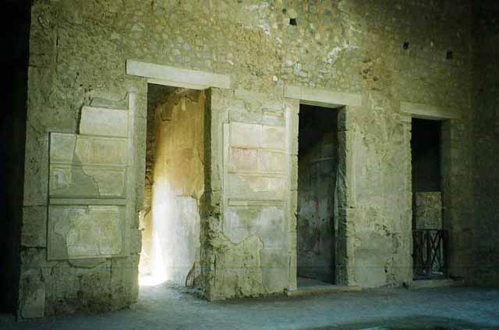 VI.2.4 Pompeii. June 2010. South side of atrium, looking south-west. 
The doorway on the left leads through to the garden apartments. The central doorway is into a cubiculum. Photo courtesy of Rick Bauer.