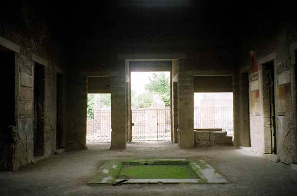 VI.2.4 Pompeii. May 2010. Looking west from rear of atrium across impluvium towards entrance, centre. The doorway to VI.2.3 is on the left of it, and to VI.2.5 is on the right of it. Photo courtesy of Rick Bauer.