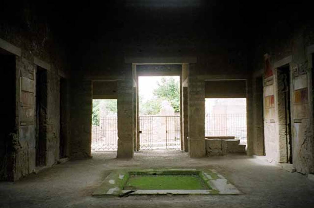 VI.2.4 Pompeii. May 2010. Looking west from rear of atrium across impluvium towards entrance, centre. The doorway to VI.2.3 is on the left of it, and to VI.2.5 is on the right of it. Photo courtesy of Rick Bauer.