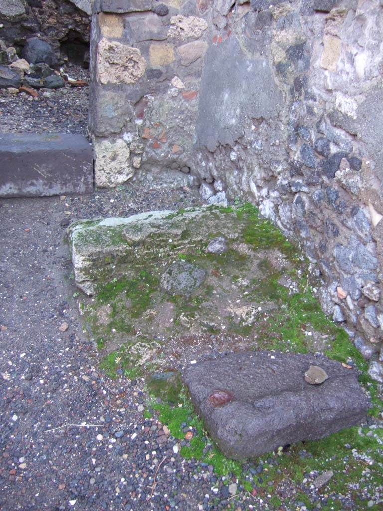 VI.2.6 Pompeii. December 2005. Stone base of stairs to upper floor near south wall, opposite the oven.
In the upper left of photo is the door to the rear room. 
According to Hobson in the corner under the site of the stairs, may have been the latrine.
See Hobson, B. 2009. Pompeii, Latrines and Down Pipes. Oxford, Hadrian Books, (p.185 & 188).
According to Fiorelli, at the side of the entrance doorway was the bread-shop, with hearth and the latrine.
See Pappalardo, U., 2001. La Descrizione di Pompei per Giuseppe Fiorelli (1875). Napoli: Massa Editore. (p.50)