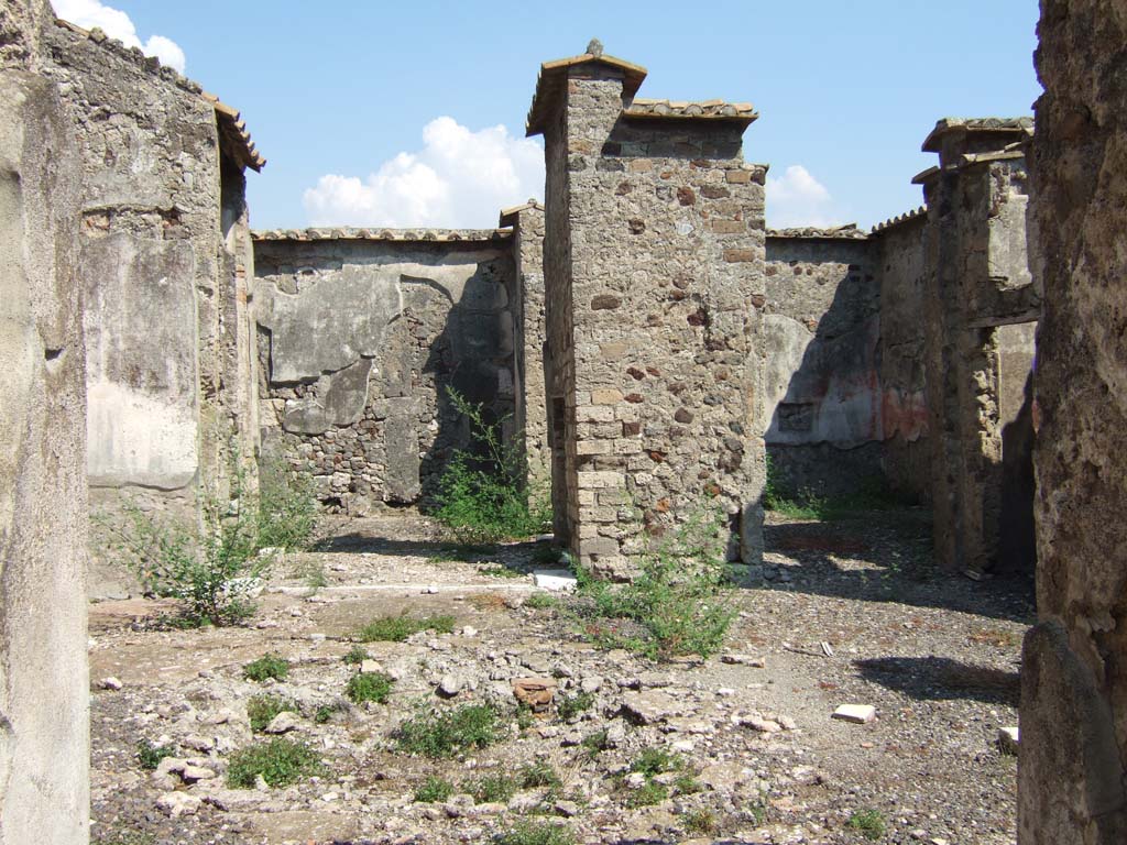VI.2.14 Pompeii. September 2005. 
Looking east across the atrium from the entrance corridor, looking through the small tablinum towards the east wall of the garden area, on left.  
On the right is an oecus, looking through doorway towards south-east corner. The south side of the atrium was not photographed.
According to Kuivalainen, in the oecus was a painting of a figure sitting on a barrel.
He comments: Most sources do not mention this painting at all. 
Bacchus and a barrel is a rare combination, but the playful nature of the two counterparts supports the identification. Silenus is also shown riding a donkey. 
This kind of humorous iconography is more common in Bacchic sculpture.
Barrels were relatively rare in the first century AD, with increasing use in place of amphorae becoming more usual in the later second century.
The scene combines Bacchus with his characteristic product in an unusual reference.
See Kuivalainen, I., 2021. The Portrayal of Pompeian Bacchus. Commentationes Humanarum Litterarum 140. Helsinki: Finnish Society of Sciences and Letters, (p.103, B16, D14).