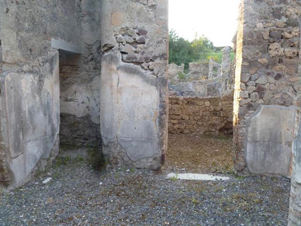 VI.2.16 Pompeii. May 2011. Looking north from peristyle. The doorway from the east end of the corridor is on the left, the doorway into an oecus is in the centre.