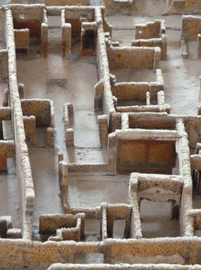 VI.2.22 Pompeii. May 2010. Looking east from rear entrance at VI.2.15 in Vicolo di Narciso. Model as viewed in Naples Archaeological Museum.