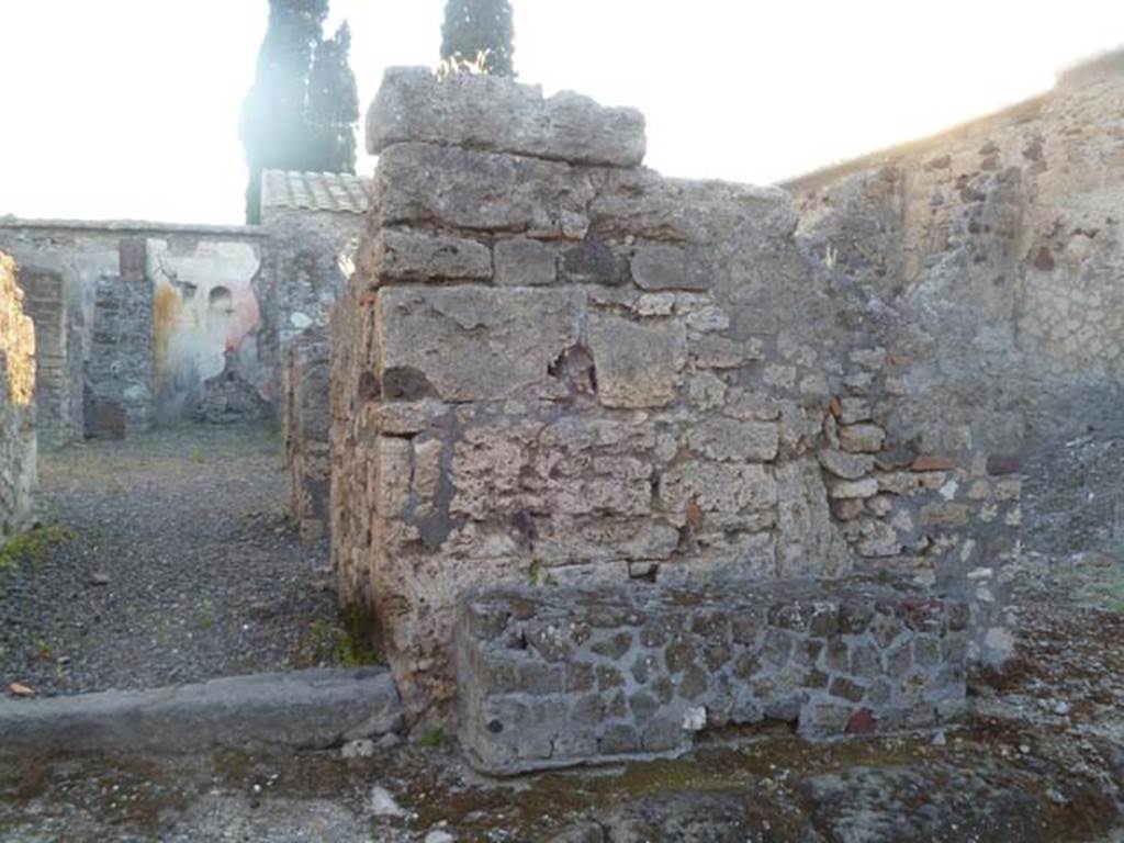VI.2.24 Pompeii. May 2011. Entrance doorway, with the remains of one of the benches outside on the right.