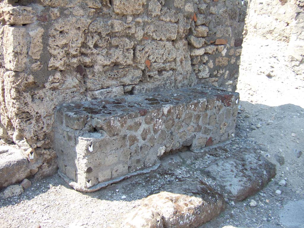 VI.2.24 Pompeii. September 2005. Bench outside, between VI.2.24 and VI.2.23.  
According to Fiorelli there were two benches for sitting at the sides of the doorway.
See Pappalardo, U., 2001. La Descrizione di Pompei per Giuseppe Fiorelli (1875). Napoli: Massa Editore. (p.51)