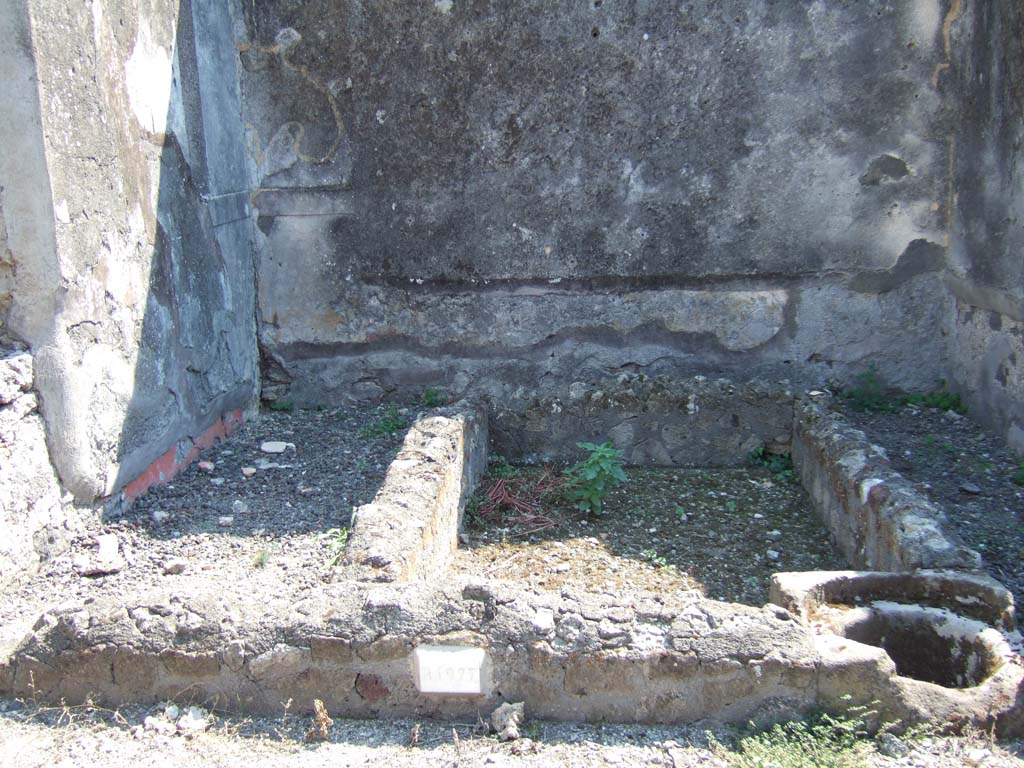 VI.2.26 Pompeii. September 2005. Looking south in yard area, towards area of small garden in centre, with basins and cistern.
According to Jashemski, this small garden in the rear south-west corner of the dwelling, was enclosed by a passageway on the east and south. 
In the east wall was a window from the nearby enclosed triclinium, on the left (not yet photographed).
See Jashemski, W. F., 1993. The Gardens of Pompeii, Volume II: Appendices. New York: Caratzas. (p.123)