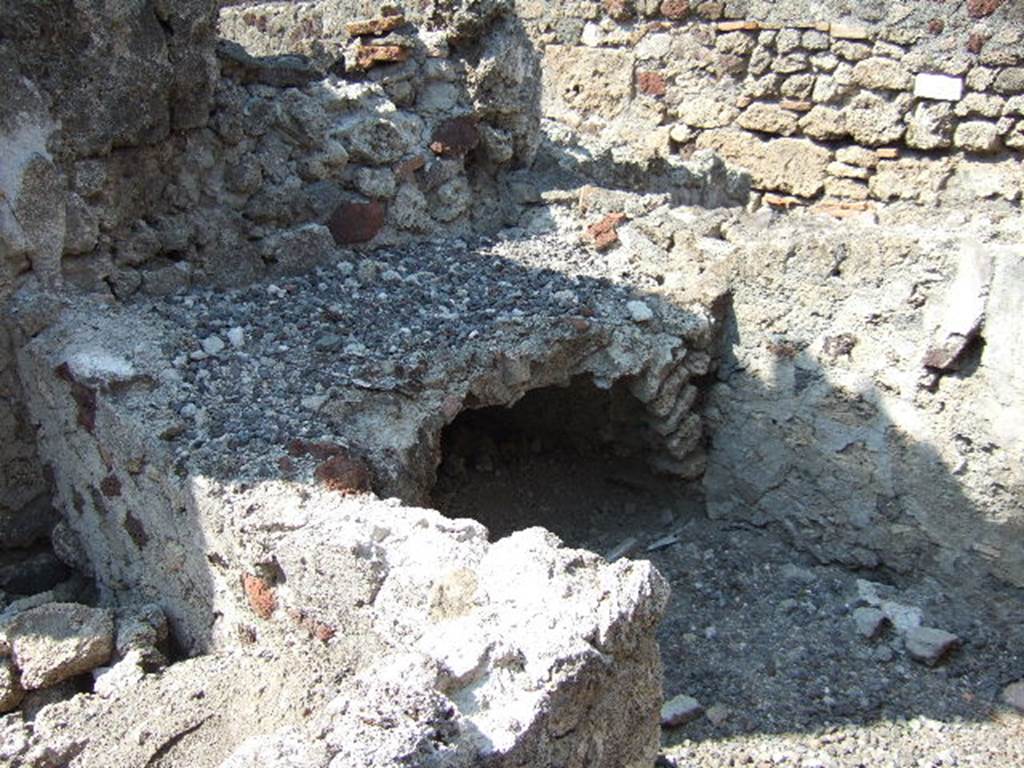 VI.2.27 Pompeii. September 2005. Kitchen hearth. According to Hobson, the kitchen had a cooking surface and a niche latrine in the same room.
Beween them was a circular cover set in a square stone slab of the floor. This could be raised by pulling on a metal ring giving access to the cess-pit. See Hobson, B., 2009. Latrinae et foricae: Toilets in the Roman World. London; Duckworth. (p.90)