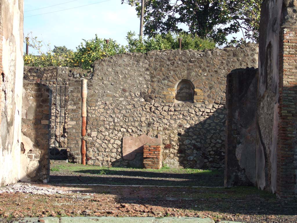 VI.3.7 Pompeii. December 2005. Looking east towards remains of masonry altar and niche in the garden area.
According to Boyce, the niche was undecorated, but the altar was coated with red stucco. 
Behind the altar was a rectangle of white stucco, which served as a background for the Lararium painting.
See Boyce G. K., 1937. Corpus of the Lararia of Pompeii. Rome: MAAR 14. (p.45, and pl.12,2 and 4) 
See Giacobello, F., 2008. Larari Pompeiani: Iconografia e culto dei Lari in ambito domestico. Milano: LED Edizioni. (p.172)