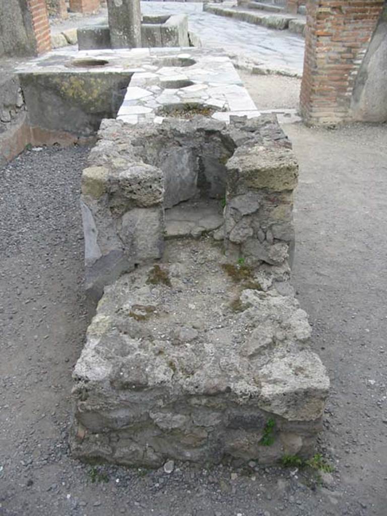 VI.3.20 Pompeii. May 2003. Looking south across hearth at rear of counter. 
Photo courtesy of Nicolas Monteix.