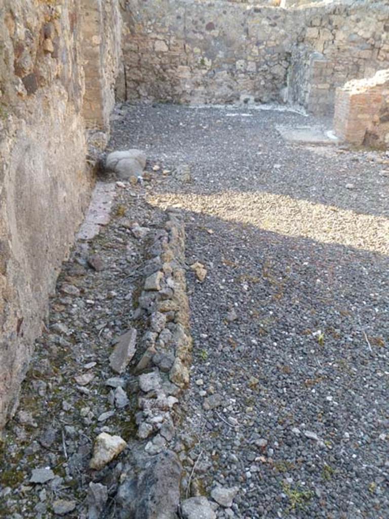 VI.5.10 Pompeii. May 2011. Room 16, looking north along base of west wall.