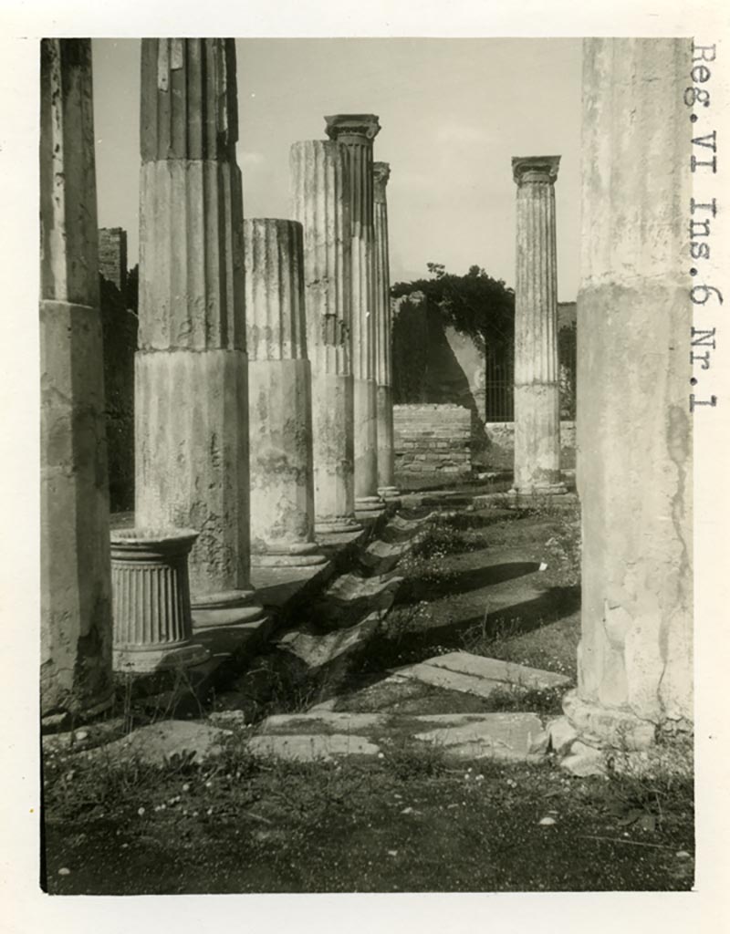 VI.6.1 Pompeii. Pre-1937-39. Looking north along west side of peristyle, with gutter and puteal.
Photo courtesy of American Academy in Rome, Photographic Archive. Warsher collection no. 1392.