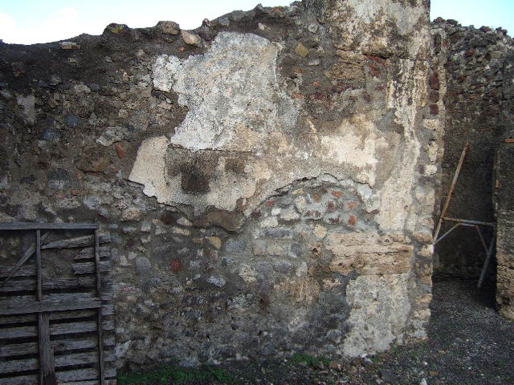 VI.6.9 Pompeii. December 2005. North wall of atrium with remains of painted plaster. On the right is the doorway leading to the kitchen.