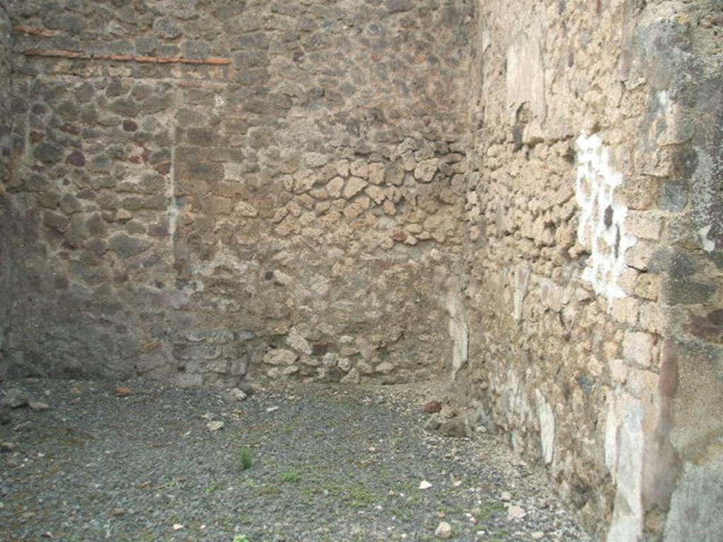 VI.6.10 Pompeii.May 2005. North side of tablinum, with blocked doorway to VI.6.1, in west wall.